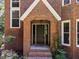 Inviting front entrance featuring a brick archway and classic door at 11425 Horsemans Trl, Raleigh, NC 27613