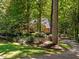 Brick home nestled behind a large front yard with a circular driveway at 11425 Horsemans Trl, Raleigh, NC 27613