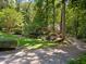 Manicured front yard with mature trees, landscaping, and a circular driveway at 11425 Horsemans Trl, Raleigh, NC 27613