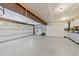 Spacious two car garage with large I-beam, finished flooring, and storage space at 11425 Horsemans Trl, Raleigh, NC 27613