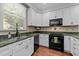 Well-equipped kitchen featuring granite countertops and classic white cabinetry at 11425 Horsemans Trl, Raleigh, NC 27613