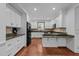 Modern kitchen featuring white cabinets, granite countertops, and stainless steel appliances at 11425 Horsemans Trl, Raleigh, NC 27613