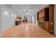 Open-concept living area with a fireplace, wood floors, and basement kitchenette at 11425 Horsemans Trl, Raleigh, NC 27613