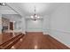 Spacious living room featuring hardwood floors and elegant pillars at 11425 Horsemans Trl, Raleigh, NC 27613