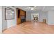 Open living room with fireplace, hardwood floors and view to the adjacent game room at 11425 Horsemans Trl, Raleigh, NC 27613