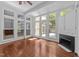 Sunroom with hardwood floors, a fireplace, built-in cabinets, and many windows for an abundance of light at 11425 Horsemans Trl, Raleigh, NC 27613