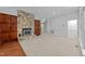 Spacious living room with a stone fireplace, built-in cabinets, carpet and hardwood flooring at 11425 Horsemans Trl, Raleigh, NC 27613