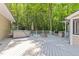 Outdoor deck with a hot tub, a built-in barbecue grill, firepit, and beautiful wooded views at 11425 Horsemans Trl, Raleigh, NC 27613