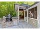 Outdoor kitchen with a built-in barbecue grill and a view of the screened in porch at 11425 Horsemans Trl, Raleigh, NC 27613
