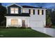 Two-story home with a blue gable, white siding, a two-car garage, and a well-manicured lawn at 1143 Winding Spring Dr, Mebane, NC 27302