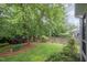 Serene backyard featuring mature trees, beautiful landscaping and partial fencing at 1208 Dunn Creek Xing, Wake Forest, NC 27587