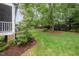 Well-maintained backyard featuring lush greenery, mature trees, and tasteful landscaping at 1208 Dunn Creek Xing, Wake Forest, NC 27587