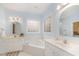 Bathroom featuring double vanity sinks, tub, and windows that allow natural light at 1208 Dunn Creek Xing, Wake Forest, NC 27587
