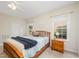 Bright bedroom with natural light, wooden bed, and two windows enhancing the inviting ambiance at 1208 Dunn Creek Xing, Wake Forest, NC 27587