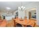 Open concept dining area with hardwood floors, a chandelier, and views into the kitchen at 1208 Dunn Creek Xing, Wake Forest, NC 27587