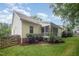 Charming home exterior featuring a screened porch, lush lawn and beautiful trees at 1208 Dunn Creek Xing, Wake Forest, NC 27587