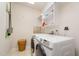 Practical laundry room with modern washer and dryer, and convenient shelving at 1208 Dunn Creek Xing, Wake Forest, NC 27587