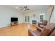 Inviting living room features a fireplace, ceiling fan, hardwood floors, and French doors leading to the outside at 1208 Dunn Creek Xing, Wake Forest, NC 27587