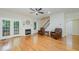 Living room showcasing hardwood floors, cozy chairs, fireplace, and a staircase for easy access to the upper level at 1208 Dunn Creek Xing, Wake Forest, NC 27587