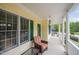 Relaxing covered front porch with seating, offering a cozy spot to enjoy the outdoors at 1208 Dunn Creek Xing, Wake Forest, NC 27587