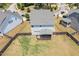 Aerial shot of the home's backyard with a patio, framed by a wooden fence in a Gathering-friendly neighborhood at 123 Gunderson Ln, Garner, NC 27529