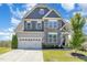 Beautiful home with a stone and siding exterior, a well-manicured lawn, and an attached two-car garage at 123 Gunderson Ln, Garner, NC 27529