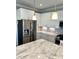 Contemporary kitchen featuring stainless steel appliances, a marble island, and sleek white cabinetry at 123 Gunderson Ln, Garner, NC 27529