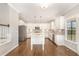 Bright, stylish kitchen featuring white cabinets, stainless steel appliances, and a marble island, offering ample counter space at 123 Gunderson Ln, Garner, NC 27529