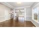 Spacious living room with hardwood floors, decorative columns, and ample natural light from large windows at 123 Gunderson Ln, Garner, NC 27529