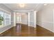 Elegant living area with hardwood floors, decorative columns, and plenty of natural light at 123 Gunderson Ln, Garner, NC 27529