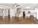 Spacious open-concept living area with hardwood floors, showcasing elegant columns, staircase, and a view into the kitchen at 123 Gunderson Ln, Garner, NC 27529