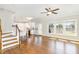 Bright and airy living room with hardwood floors and large windows overlooking the yard, adjacent to an open kitchen at 123 Gunderson Ln, Garner, NC 27529
