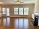 Bright living room with hardwood floors, a fireplace with built-ins, and multiple windows for natural light at 123 Gunderson Ln, Garner, NC 27529