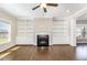 Cozy living room featuring a fireplace, built-in bookcases, and hardwood flooring at 123 Gunderson Ln, Garner, NC 27529