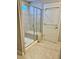 Walk-in shower featuring glass doors and built-in bench at 123 Gunderson Ln, Garner, NC 27529