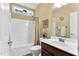 Bathroom with shower-tub combination, vanity, and natural light at 123 Holiday Island Dr, Garner, NC 27529