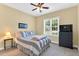 Cozy bedroom featuring a comfortable bed, soft lighting, and a view of the outdoors at 123 Holiday Island Dr, Garner, NC 27529