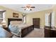 Comfortable bedroom with ceiling fan, lamps, and a beautifully crafted wardrobe, perfect for a relaxing retreat at 123 Holiday Island Dr, Garner, NC 27529