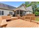 Wide angle of multi-level deck with stairs, wooden railings, bench seating, and an enclosed porch on the back of the house at 123 Holiday Island Dr, Garner, NC 27529