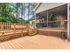 Angle of outdoor deck with stairs, lattice work, and railings, and an enclosed porch with ceiling fan in background at 123 Holiday Island Dr, Garner, NC 27529