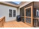 Exterior deck view featuring a grill with black cover, adjacent to the screen door leading to an enclosed porch at 123 Holiday Island Dr, Garner, NC 27529