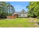 Backyard view showcases a large, well-maintained lawn, multi-tiered deck, and screened-in porch, perfect for outdoor enjoyment at 123 Holiday Island Dr, Garner, NC 27529