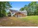 Expansive backyard featuring a deck, screened-in porch, and ample space, blending seamlessly with the natural surroundings at 123 Holiday Island Dr, Garner, NC 27529