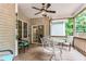 Cozy covered porch features ceiling fan, decorative wall hangings, and outdoor seating area with sliding glass door access at 123 Holiday Island Dr, Garner, NC 27529