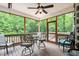 Screened porch with outdoor seating and view of trees providing an open-air space for relaxation and entertaining at 123 Holiday Island Dr, Garner, NC 27529