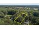 Aerial view of land parcel surrounded by lush green trees, property lines are estimate at 1302 Buffaloe Rd, Garner, NC 27529