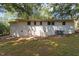 Exterior backyard view of the home featuring brick walls and some greenery at 1302 Buffaloe Rd, Garner, NC 27529