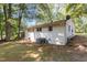 Backyard view of the home's exterior, featuring a brick wall and some greenery at 1302 Buffaloe Rd, Garner, NC 27529