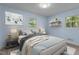Well-lit bedroom featuring a full bed, sleek nightstands, and two windows at 1302 Buffaloe Rd, Garner, NC 27529