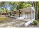 Charming exterior view showcasing a porch swing, a covered entrance, and a driveway at 1302 Buffaloe Rd, Garner, NC 27529